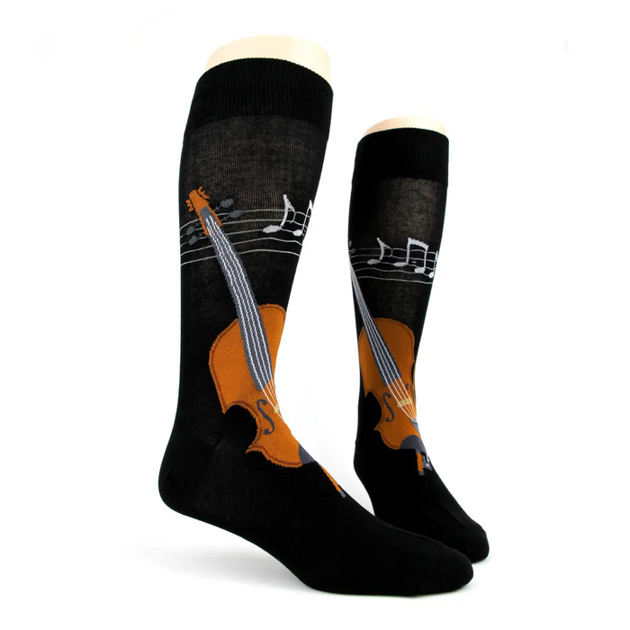Lifestyle shot: Model wearing black Musical String socks with brown loafers and dark jeans.