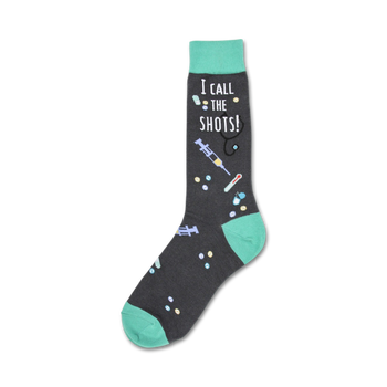 black crew socks with green toes/heels and white "i call the shots!" text. medical symbols such as pills, syringes, stethoscopes, and thermometers are also featured.   