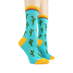 Pair of Cactus socks on mannequin legs showing the full design.