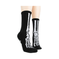 Lifestyle shot of model wearing black skeleton socks with grey non-skid bottoms.