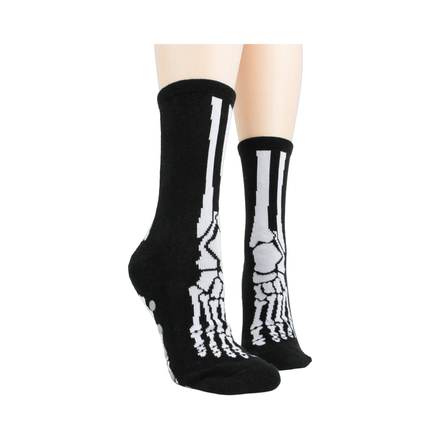 Lifestyle shot of model wearing black skeleton socks with grey non-skid bottoms.