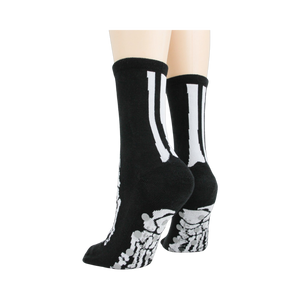 Flat lay image showcasing a pair of black skeleton socks.