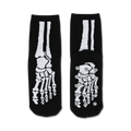 Pair of black non-skid slipper socks with a white skeleton bone design. Grippy dots on the bottom.
