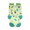 Pair of crew socks, light green with teal accents, featuring gardening tools, bees, sunflowers and other garden elements.