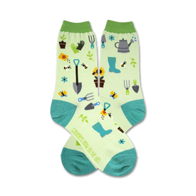 white women's crew socks with green toes and cuffs. gardening tool and flower pattern.  
