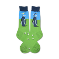 Pair of crew socks with a golf-themed design. The socks are green with a blue section showing golf clubs in a bag, and white golf balls are scattered on the green.