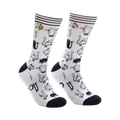 A pair of white crew socks covered in a repeating pattern of black and white cartoon cats. The socks have black heels and toes.