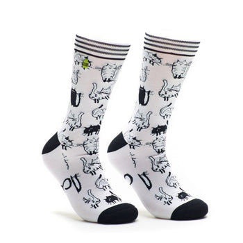 A pair of white crew socks covered in a repeating pattern of black and white cartoon cats. The socks have black heels and toes.