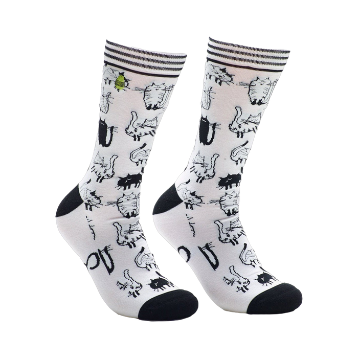 A pair of white crew socks covered in a repeating pattern of black and white cartoon cats. The socks have black heels and toes. }}
