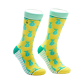 A pair of crew socks in yellow with teal pineapples. The cuffs are mint green and white stripes accent the heel and toe.