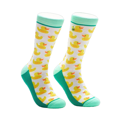 A pair of crew socks with a white background and a repeating pattern of yellow rubber duckies. Teal green accents at the top and bottom.