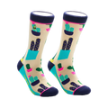 Pair of crew socks with a beige background and a colorful cactus design.  Features teal, navy, and pink accents.