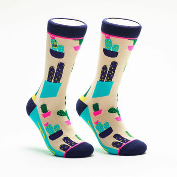 Pair of crew socks with a beige background and a colorful cactus design.  Features teal, navy, and pink accents.