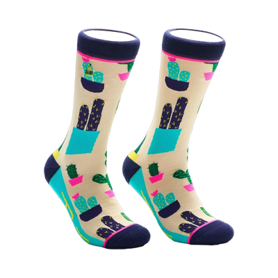 Pair of crew socks with a beige background and a colorful cactus design.  Features teal, navy, and pink accents.