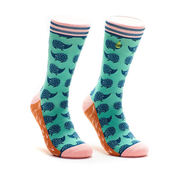 Pair of teal crew socks with a navy hedgehog pattern, pink and orange accents, and a small yellow pear graphic.
