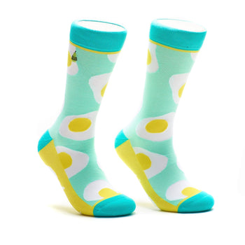 Crew socks with a mint green background and a repeated pattern of sunny-side up eggs in yellow and white. Turquoise accents at the top and bottom.