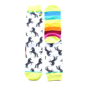 Pair of crew socks. One sock has a white background with black unicorn silhouettes. The other sock has a rainbow stripe pattern.