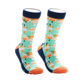 A pair of crew socks with a mint green background and repeating pattern of orange cakes with candles. The socks have navy blue cuffs and orange toes.