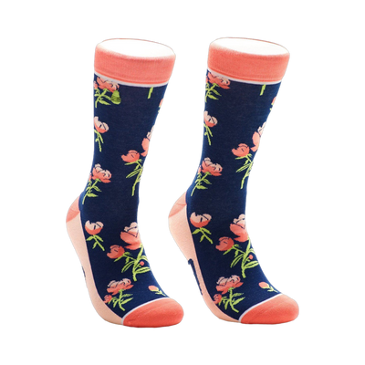 A pair of navy blue crew socks with a pattern of coral peonies and green stems. The socks have a coral-colored cuff.
