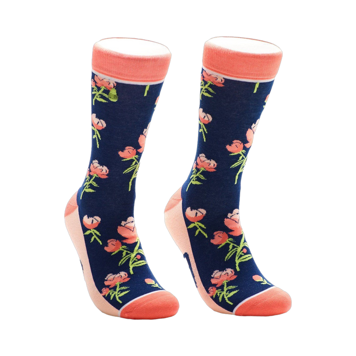 A pair of navy blue crew socks with a pattern of coral peonies and green stems. The socks have a coral-colored cuff. }}