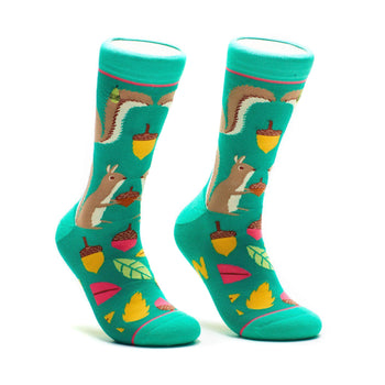 Pair of teal crew socks with illustrated squirrels, acorns, and autumn leaves. Fun and quirky design.
