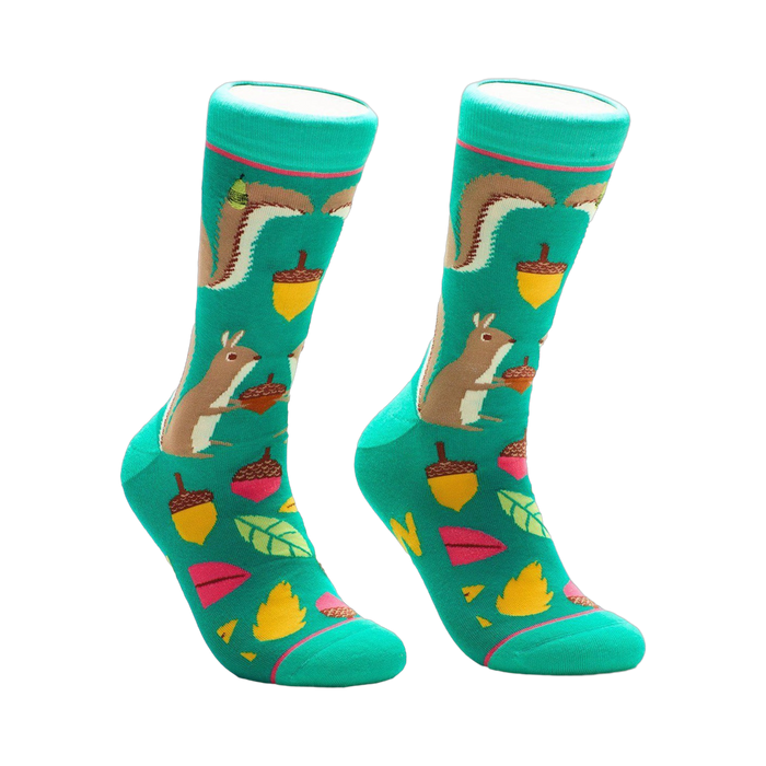 Pair of teal crew socks with illustrated squirrels, acorns, and autumn leaves. Fun and quirky design.