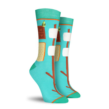 Pair of teal crew socks with a s'mores design.  Features graham crackers, marshmallows, chocolate, and roasting sticks on a teal background.