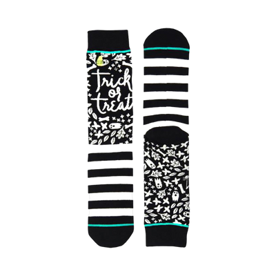 Pair of black and white striped crew socks. One sock features 'Trick or Treat' in script with Halloween-themed illustrations. Teal accents on cuffs.
