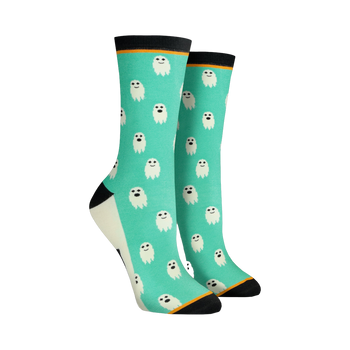 Pair of women's crew socks. Teal background with repeating pattern of small white ghosts. Black and orange cuffs.