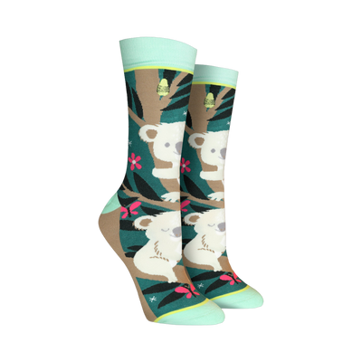 Crew socks with a teal, brown, and pink design. Koalas are featured on a eucalyptus tree background with pink flowers and butterflies.