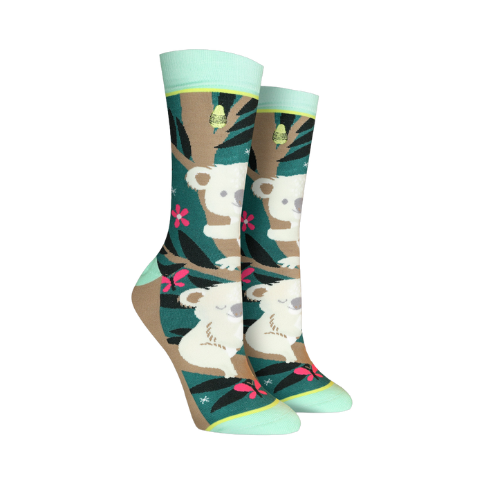 Crew socks with a teal, brown, and pink design. Koalas are featured on a eucalyptus tree background with pink flowers and butterflies. }}