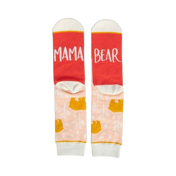 Pair of women's crew socks. Peach background with gold bear design. Red heel and toe with 'Mama Bear' text.