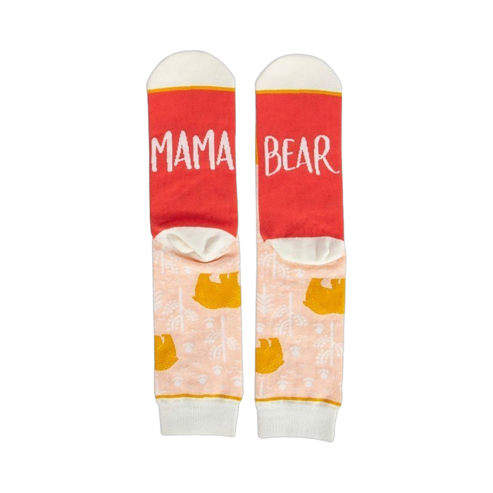 Pair of women's crew socks. Peach background with gold bear design. Red heel and toe with 'Mama Bear' text.