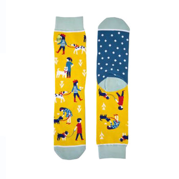 Crew socks in yellow with teal accents. Features illustrated people walking their dogs and a teal polka dot heel.