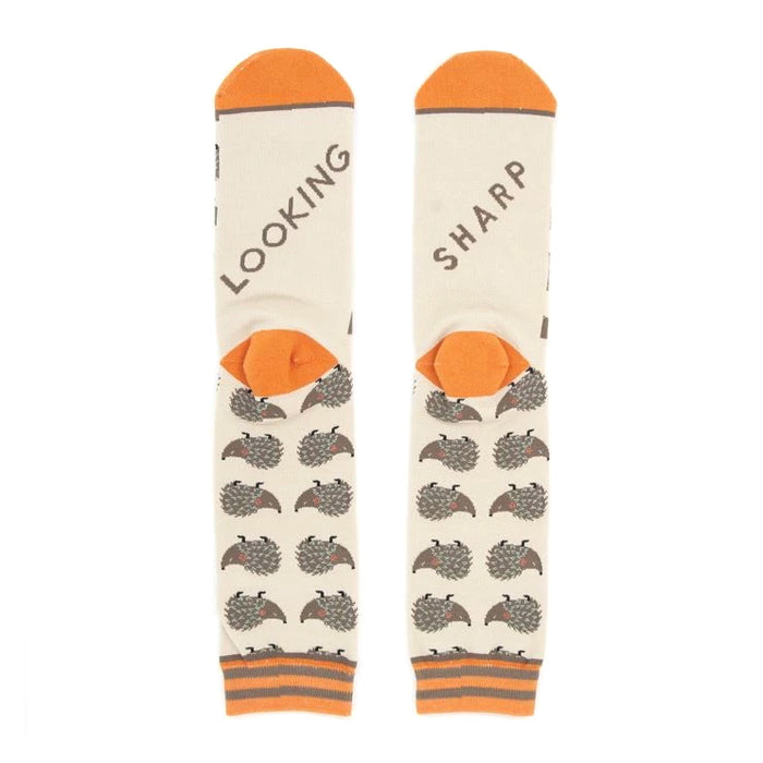 Close-up shot of the socks' heels, revealing 'LOOKING' and 'SHARP' text.