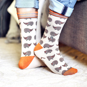 Lifestyle shot of a person wearing the 'Looking Sharp' hedgehog socks.
