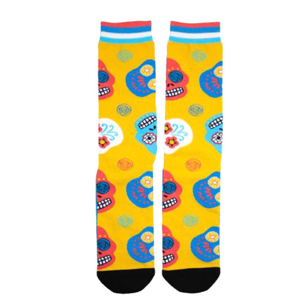 Crew socks in yellow with a fun pattern of colorful sugar skulls.  Pink, blue, and red skulls with floral details are featured against the yellow background. [lf]