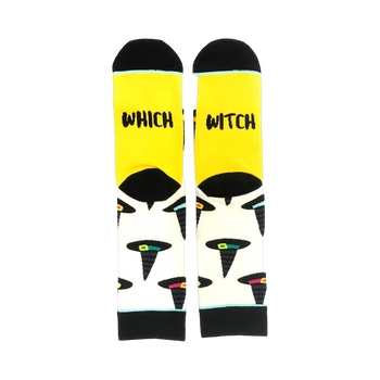 A pair of crew socks with a yellow cuff and cream body. The socks feature a pattern of black witch hats with colorful accents.  The cuff reads 'Which Witch'.