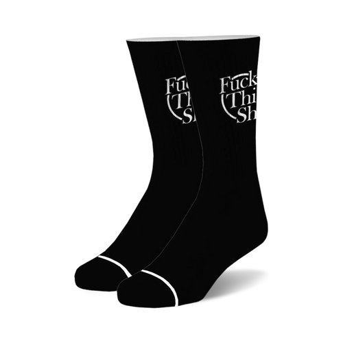 Pair of black crew socks with a white 'Fuck This Shit' logo.  Simple design, casual style.