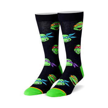 black crew socks with a repeating pattern of teenage mutant ninja turtles heads in various colors.  