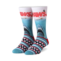 Pair of Jaws crew socks.  White and teal stripes at the bottom, featuring the Jaws movie poster with a great white shark on the main body of the sock.