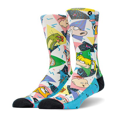 Pair of crew socks with a white base, featuring colorful 90s geometric patterns and Nickelodeon cartoon characters like Ren, Stimpy, and Rugrats. Black toes and blue heels.