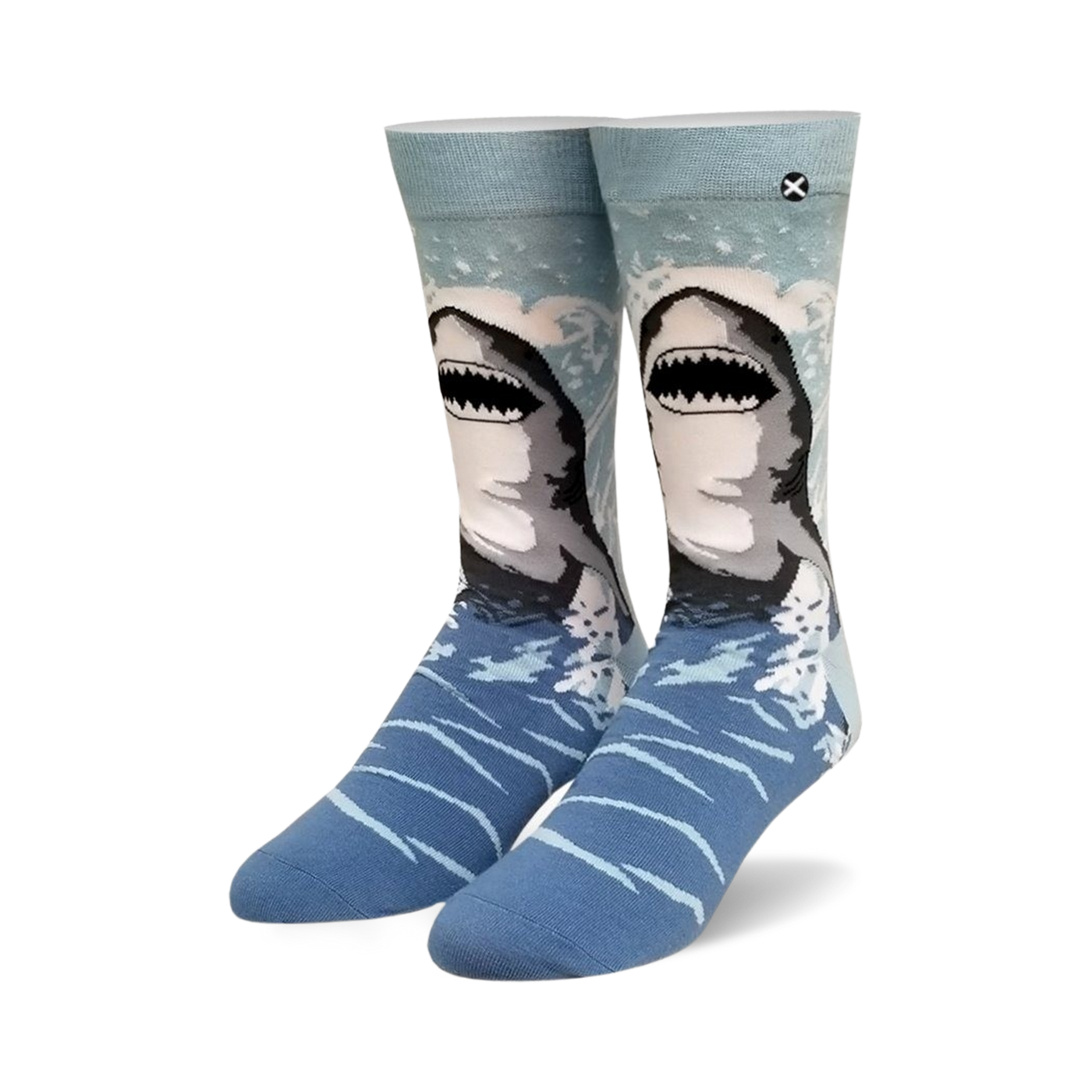 Pair of crew socks, blue and gray, with a great white shark design emerging from the water. 
