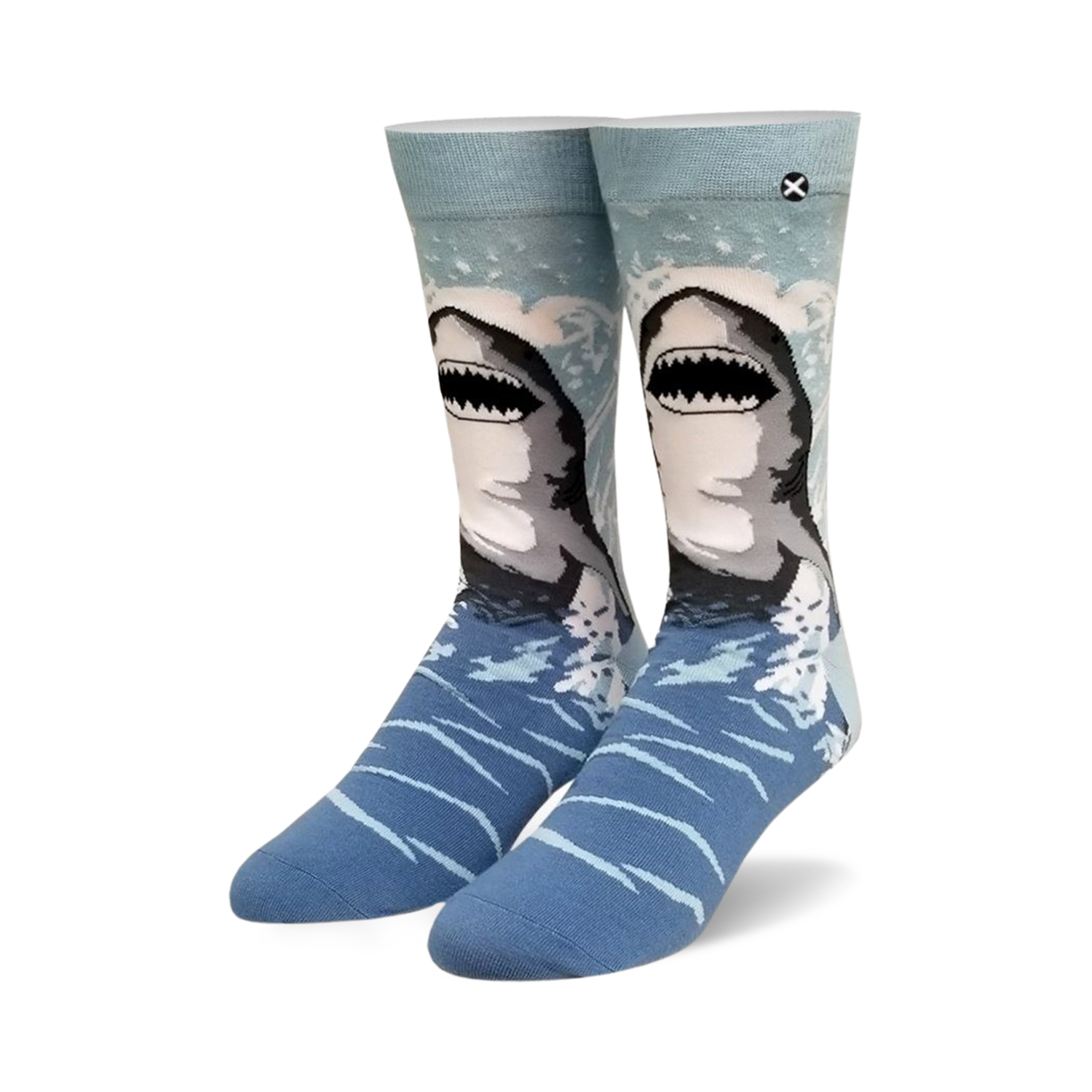 Pair of crew socks, blue and gray, with a great white shark design emerging from the water. 