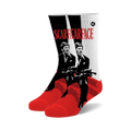 A pair of crew socks with a Scarface design.  The socks are predominantly red and white with black and white illustrations of Tony Montana holding a gun.
