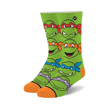 teenage mutant ninja turtles socks feature green all over pattern of the four turtles' faces with different color masks. crew length. for men and women.  