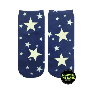Pair of navy blue ankle socks with a glow-in-the-dark design. White stars of varying sizes are scattered across the socks, with larger stars prominently featured.