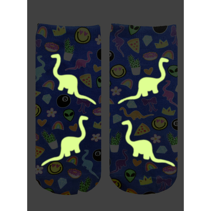 A pair of blue socks with a pattern of glow-in-the-dark dinosaurs.