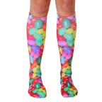 Pair of knee-high socks featuring a colorful jellybean print.  Red, green, yellow, pink, and purple jellybeans are scattered across a white background. [lf]