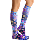 Lifestyle shot showing the Dog Cravings socks on a person's legs from the side; showcasing the fit and pattern. [lf]